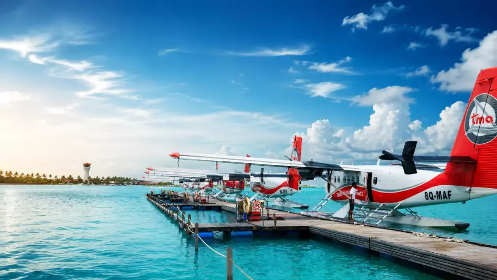 Trans Maldivian Airways Twin Otter seaplane moored at the Noovilu Seaplane Terminal dock in Malé