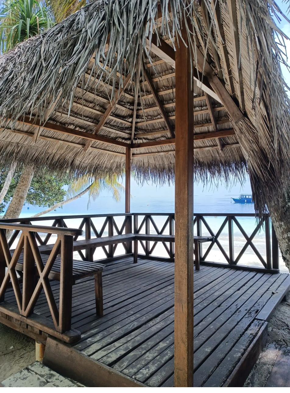 What to Do on a Wet Day in the Maldives: Rain Is Not the Problem 7 Thatched beach gazebo with wooden deck overlooking a lagoon in the Maldives