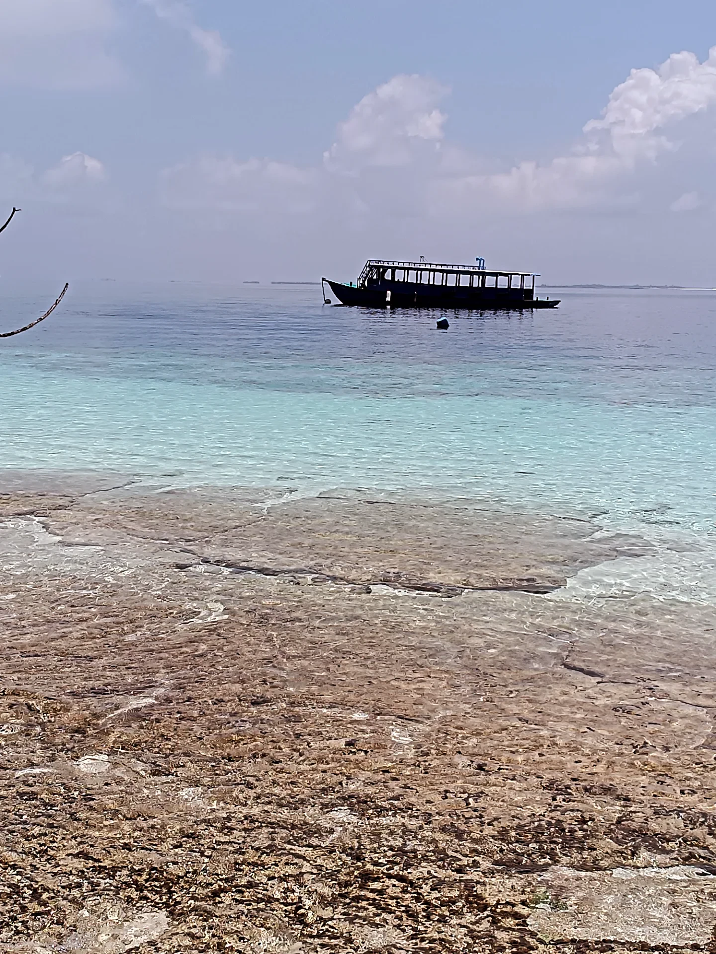 Reef flat dropping into deep blue water at the edge of a Maldivian atoll 