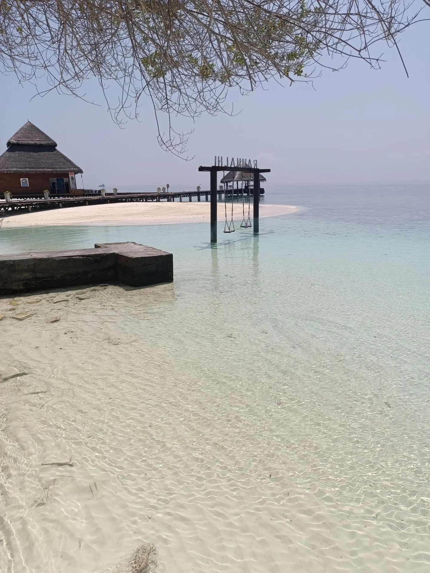 Water Sports in the Maldives: Half of It Is Free and Nobody Uses It 7 Shallow turquoise lagoon and jetty on a Maldivian island under a clear sky