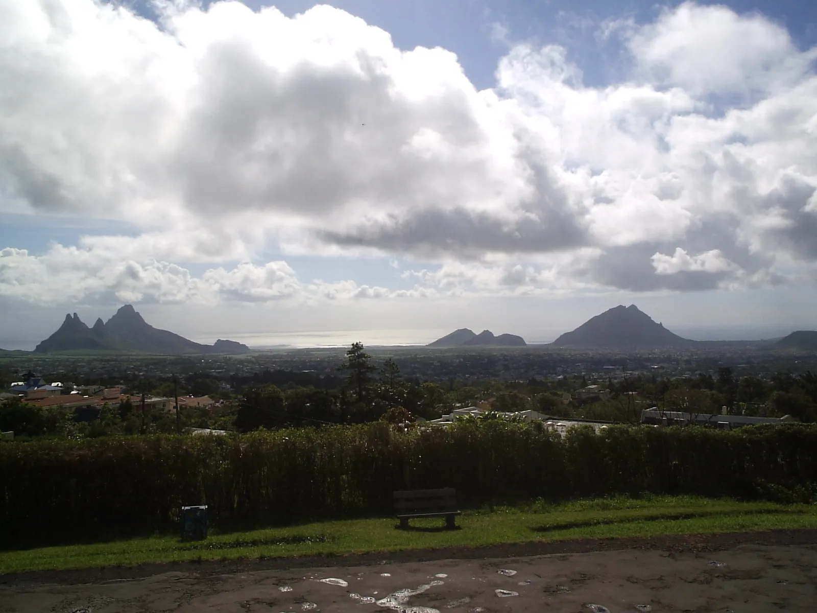 View over a Mauritian town with mountains and the sea in the distance