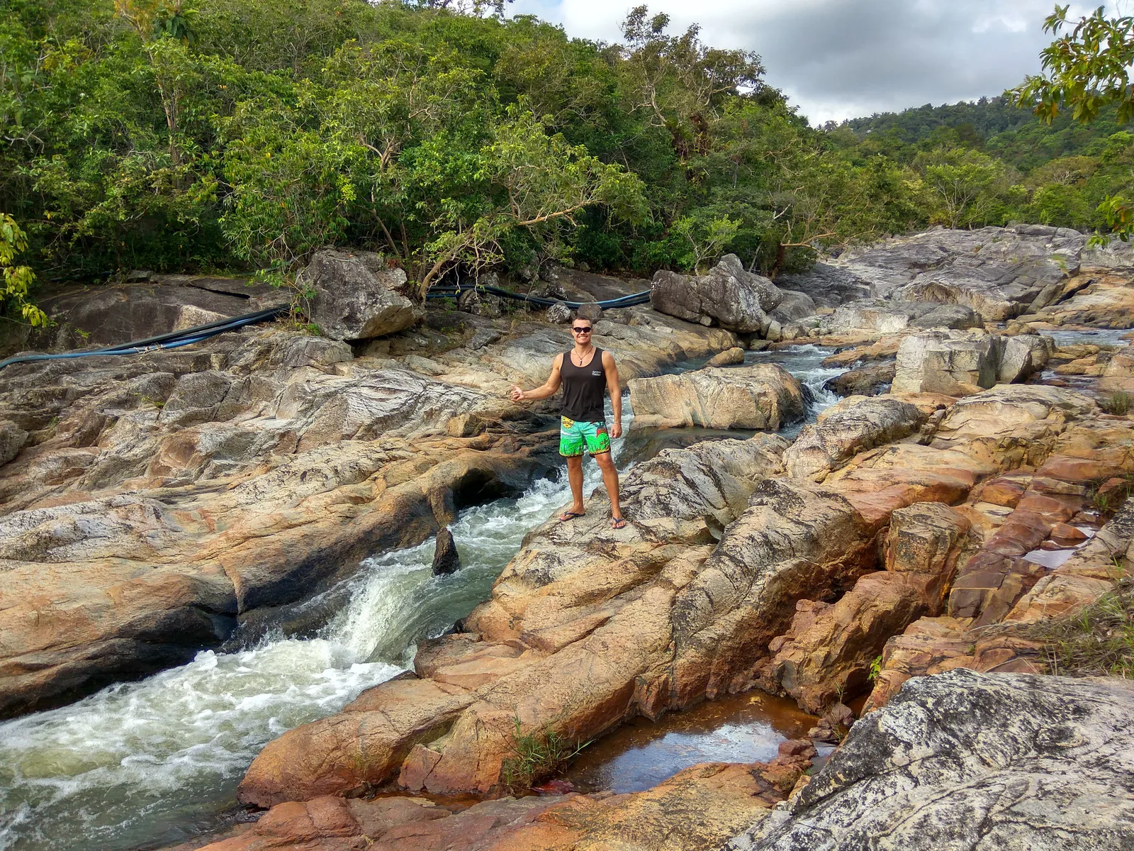 Freshwater stream running over granite boulders in tropical forest