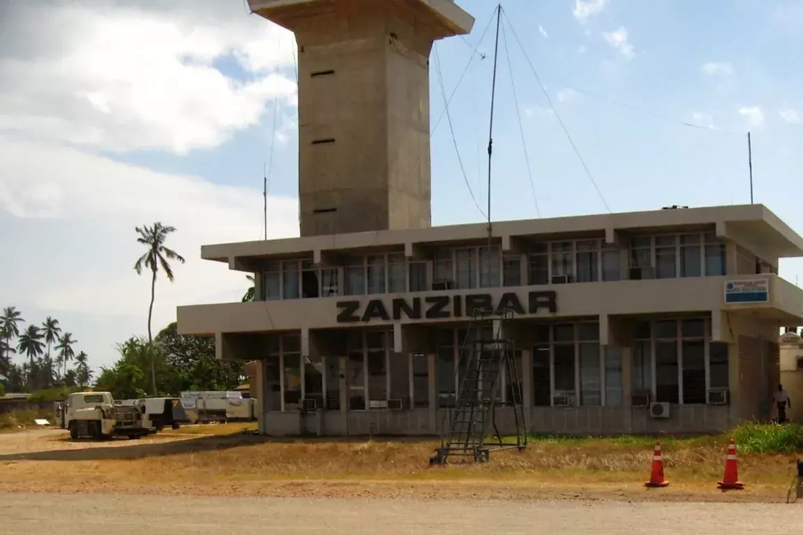 Airport terminal building with the word Zanzibar on the façade and a control tower behind